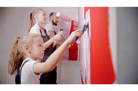 Family painting walls in red in the, a Person Photo by Barcelona_dreams