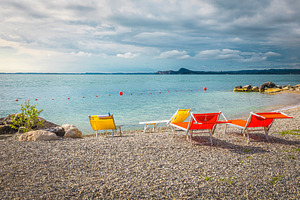 Amazing beach with colorful sunbeds, a Sports & Recreation Photo by Alpine Dreams