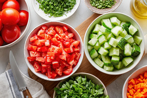 Fresh chopped tomatoes with herbs on a wooden table, a Food & Drink Photo by AlyaAnd