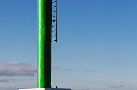 Green maritime beacon in a coastal p