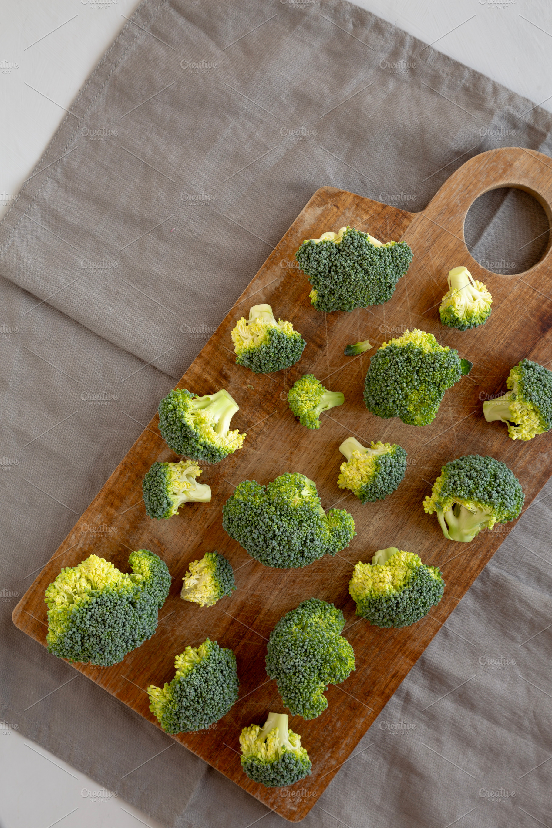 Raw Organic Green Broccoli on a Wooden Board, top view. Copy spa, a Food & Drink Photo by LiudmylaChuhunova