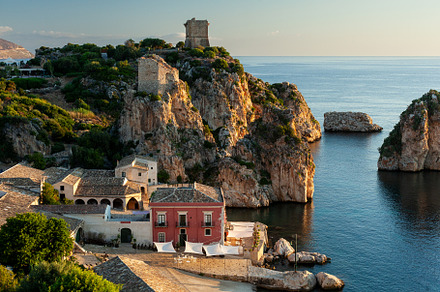 Beach and a rocky cliff at the Tonnara, Trapani, an Architecture Photo by Bepslabor