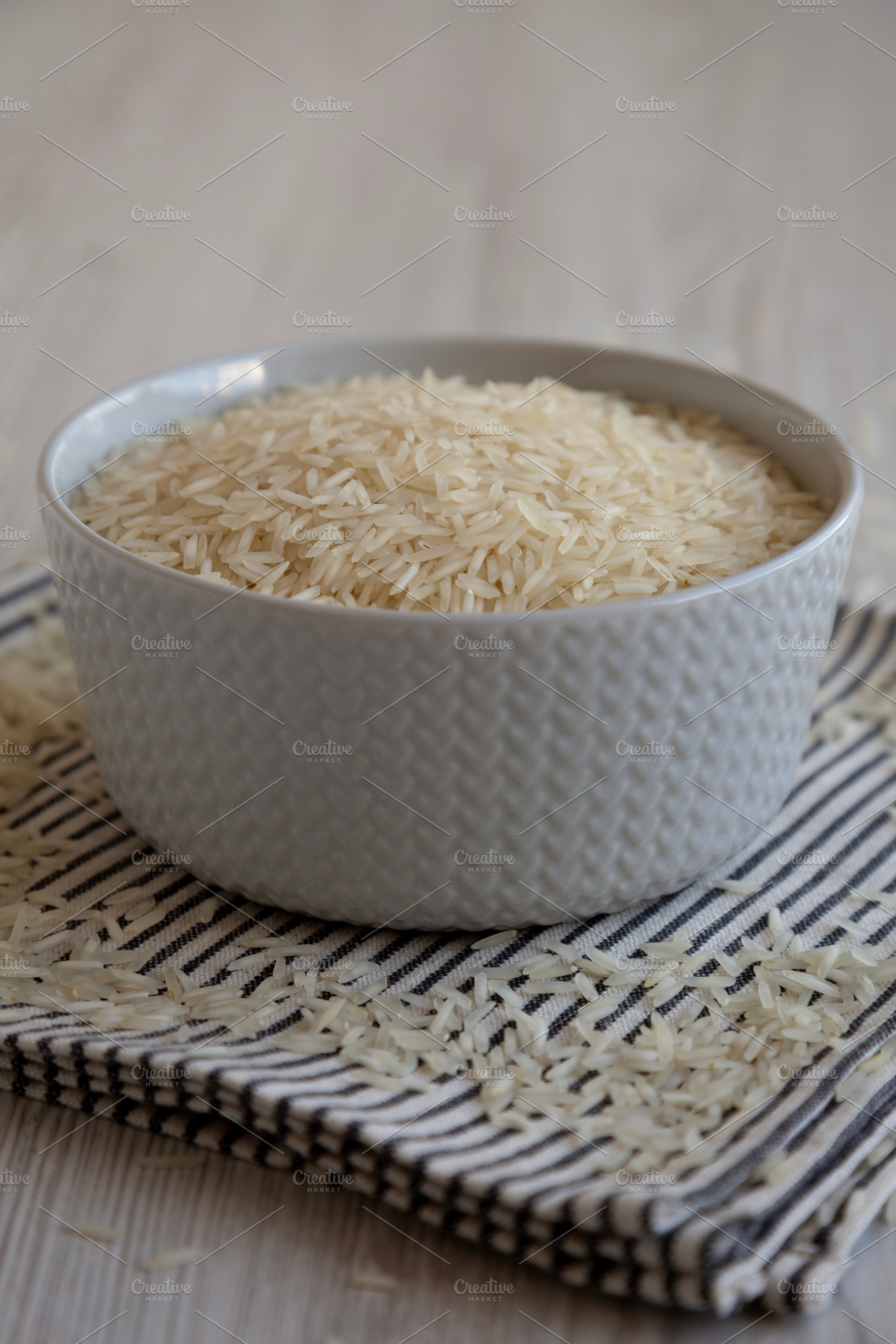 Uncooked White Organic Basmati Rice in a Bowl, side view. Close-, a Food & Drink Photo by LiudmylaChuhunova