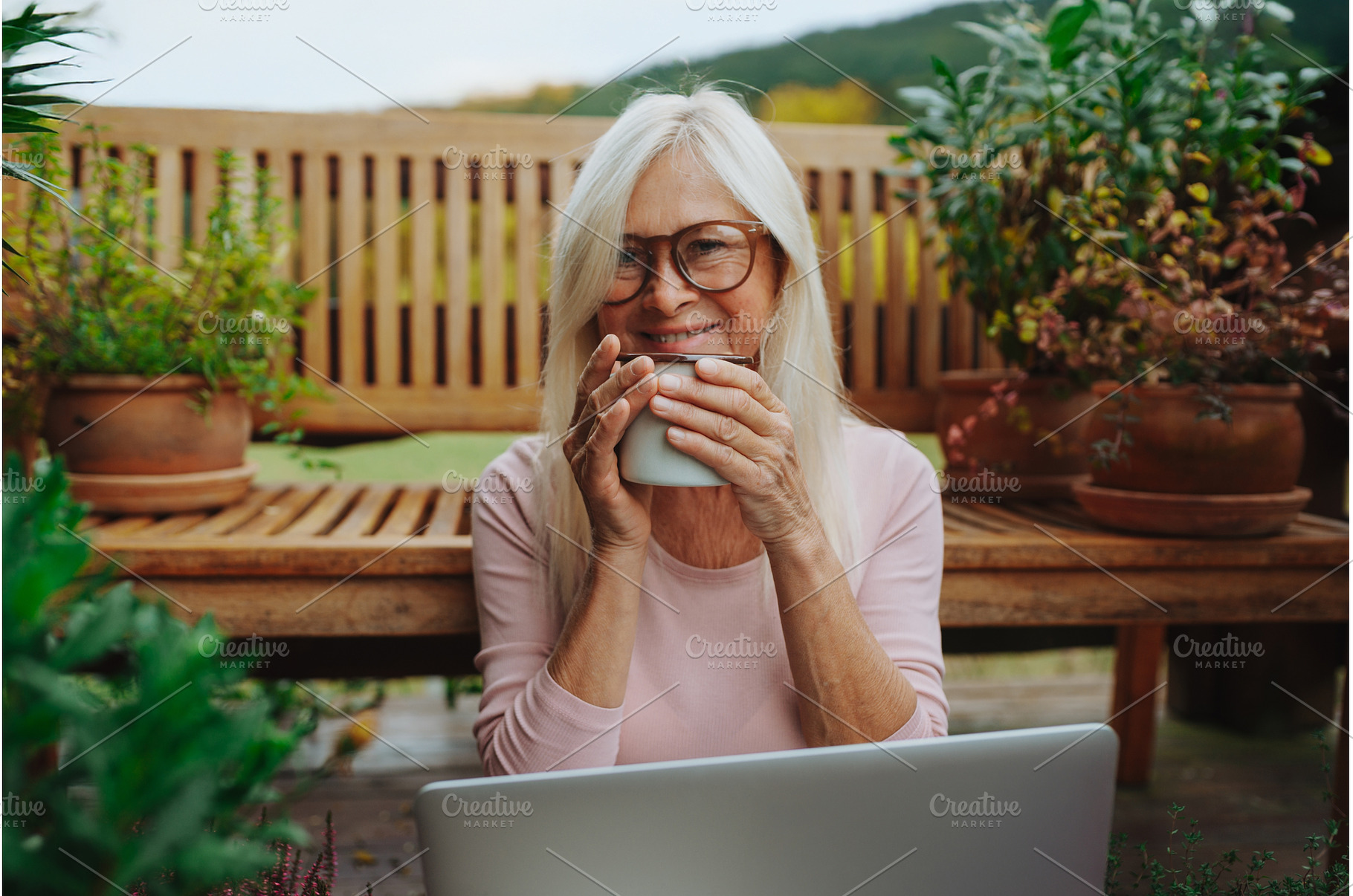 Older woman having cup of tee while, a Person Photo by HalfPoint