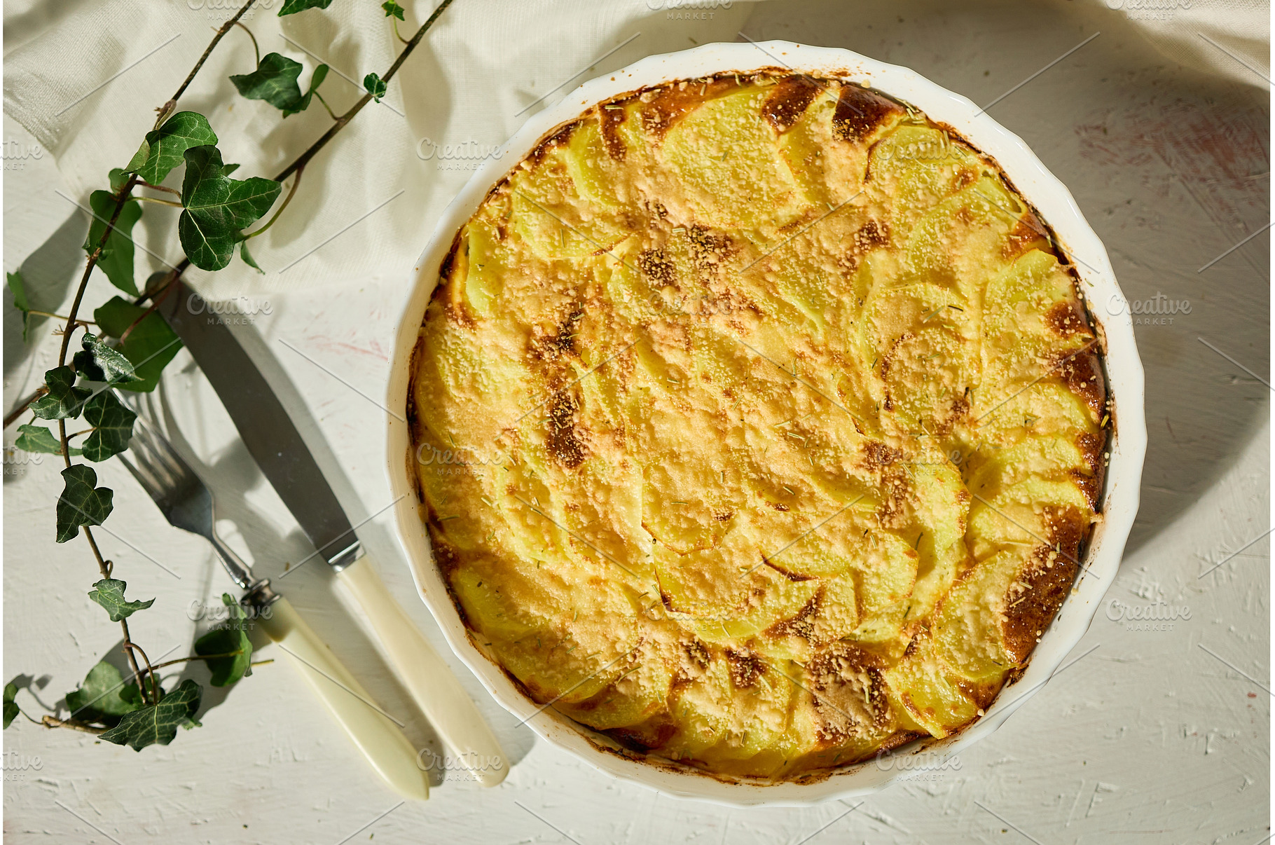 Golden gratin on a rustic table., a Food & Drink Photo by IlliaBondarPhotography