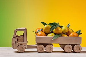  Toy wooden truck with tangerines.