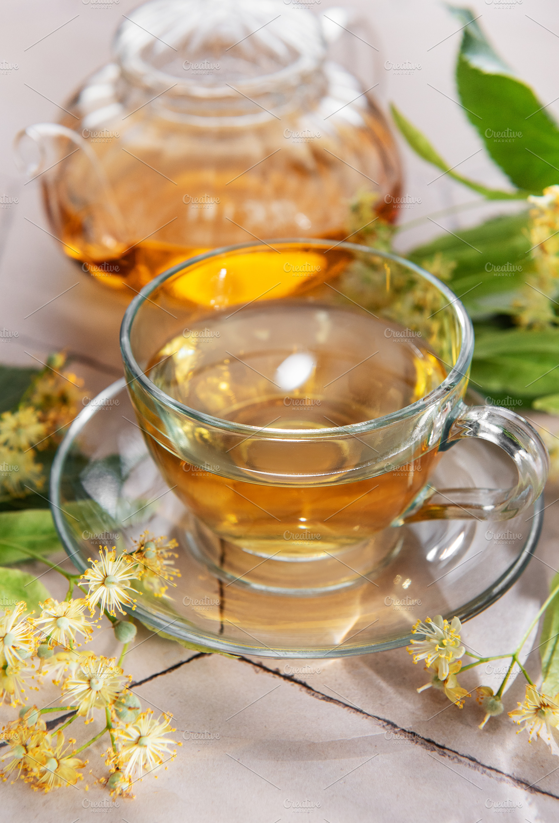 Linden tea cup and teapot brewing healthy drink, a Food & Drink Photo by Olena Rudo