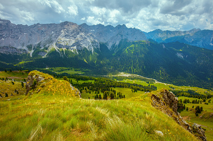 landscape with mountains, hills, clouds, grass and trees, a Nature Photo by Alliance Images