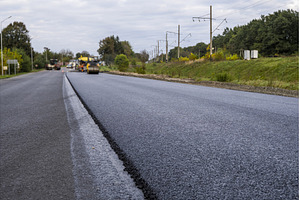 Freshly paved asphalt road with, an Industrial Photo by volodymyrshtun13795
