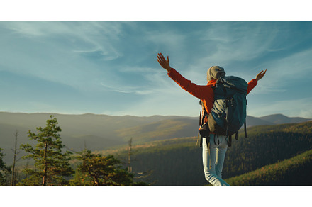 Woman hiker with backpack enjoying, a Nature Photo by vitaliymateha photography
