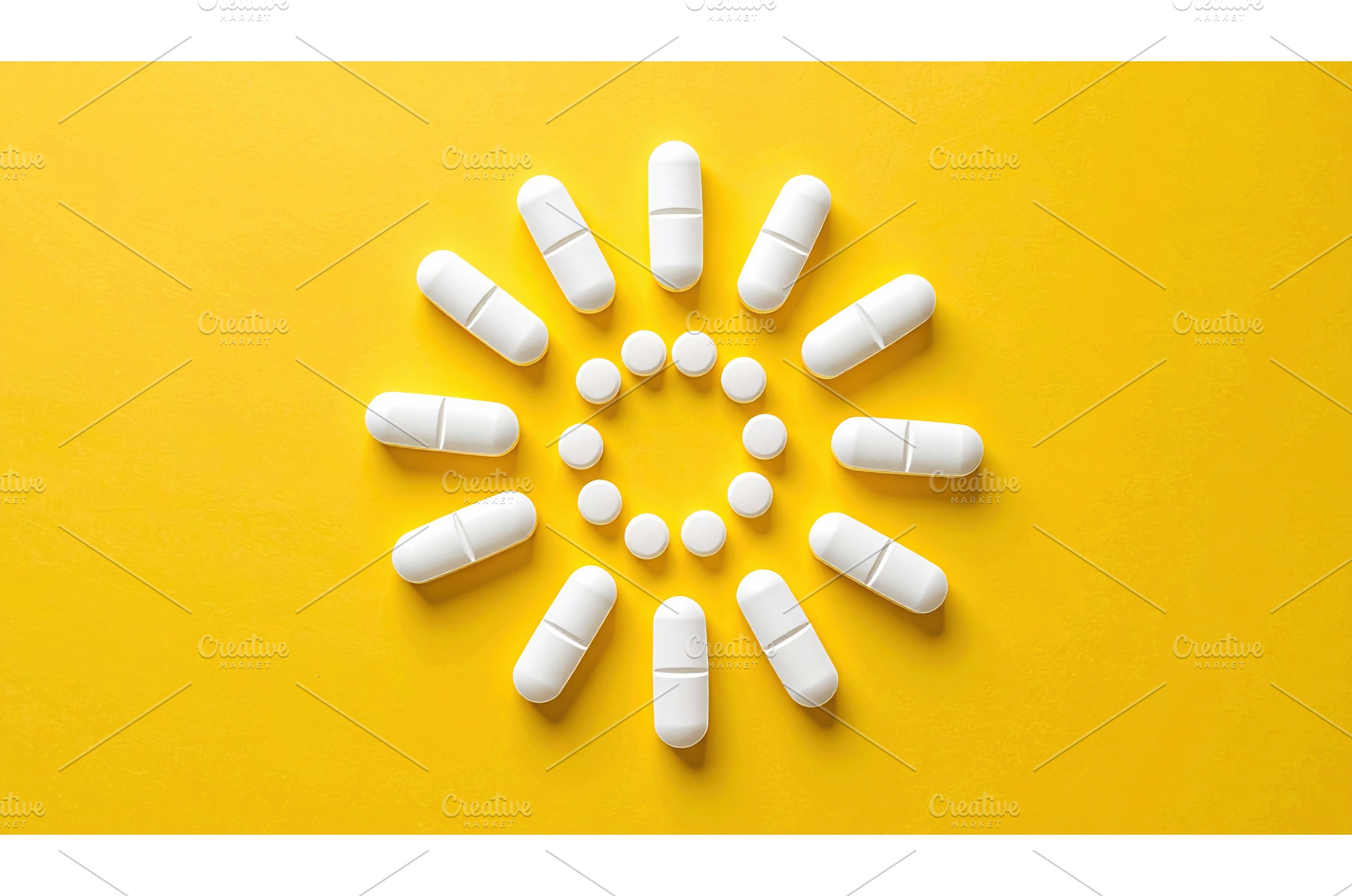 White pills arranged like a sunburst, a Health & Medical Photo by Igor Tichonow