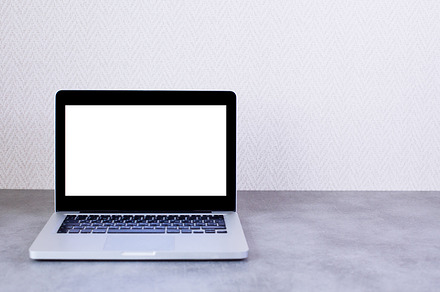 Front view of desktop with laptop featuring background, blank, and book