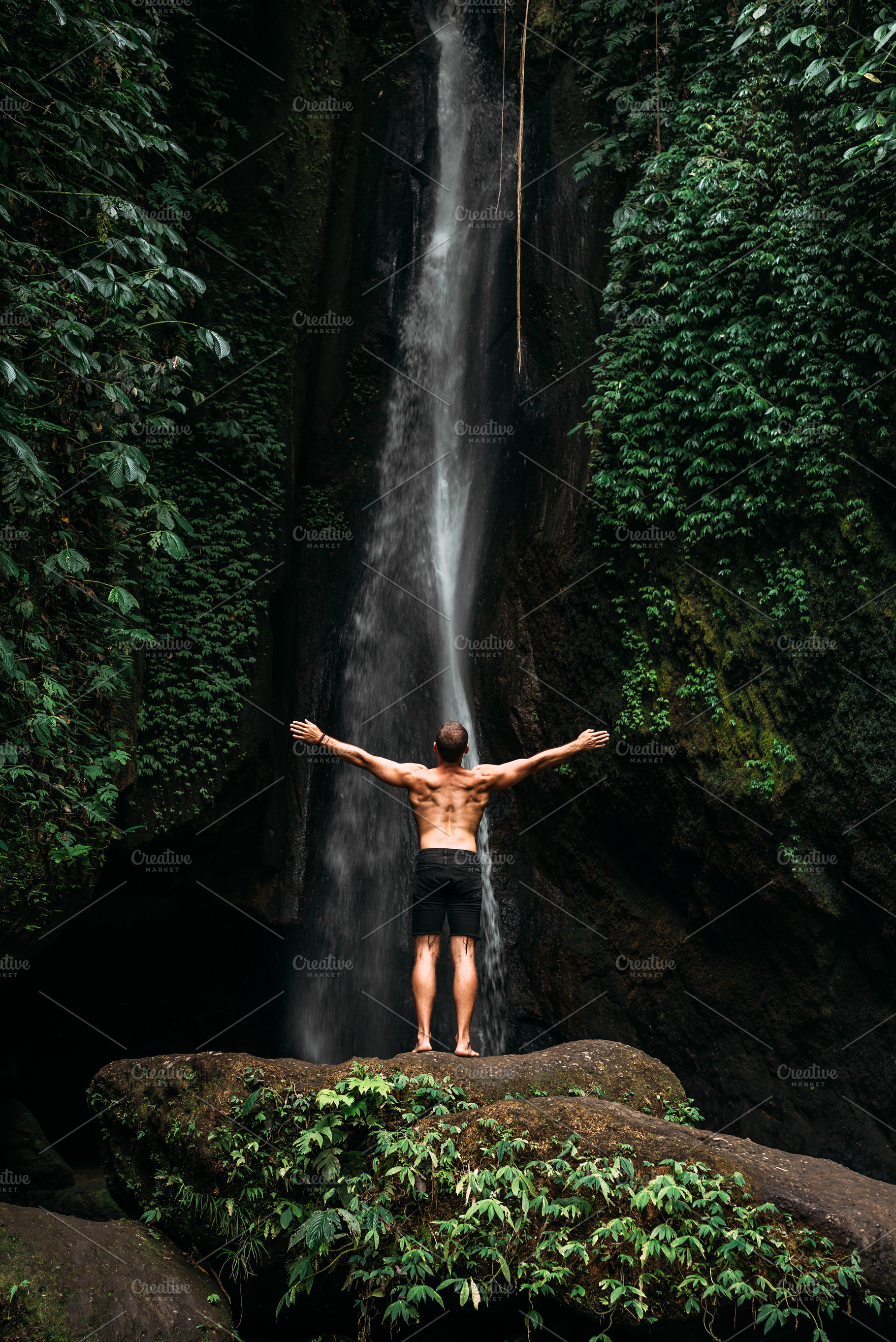 Man at the waterfall travel to bali containing active, activity, and adventure, a Person Photo by SOTNIKOV_MISHA
