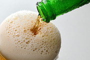 Filling glass with sparkling drink from green bottle, a Food & Drink Photo by Davizro's Market (Thumbnail 1 of 2)