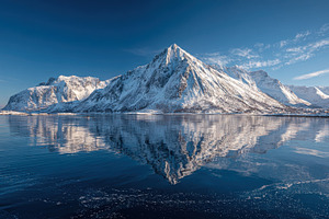 Stunning snow capped mountains refle, a Photo by Pixeness Studio