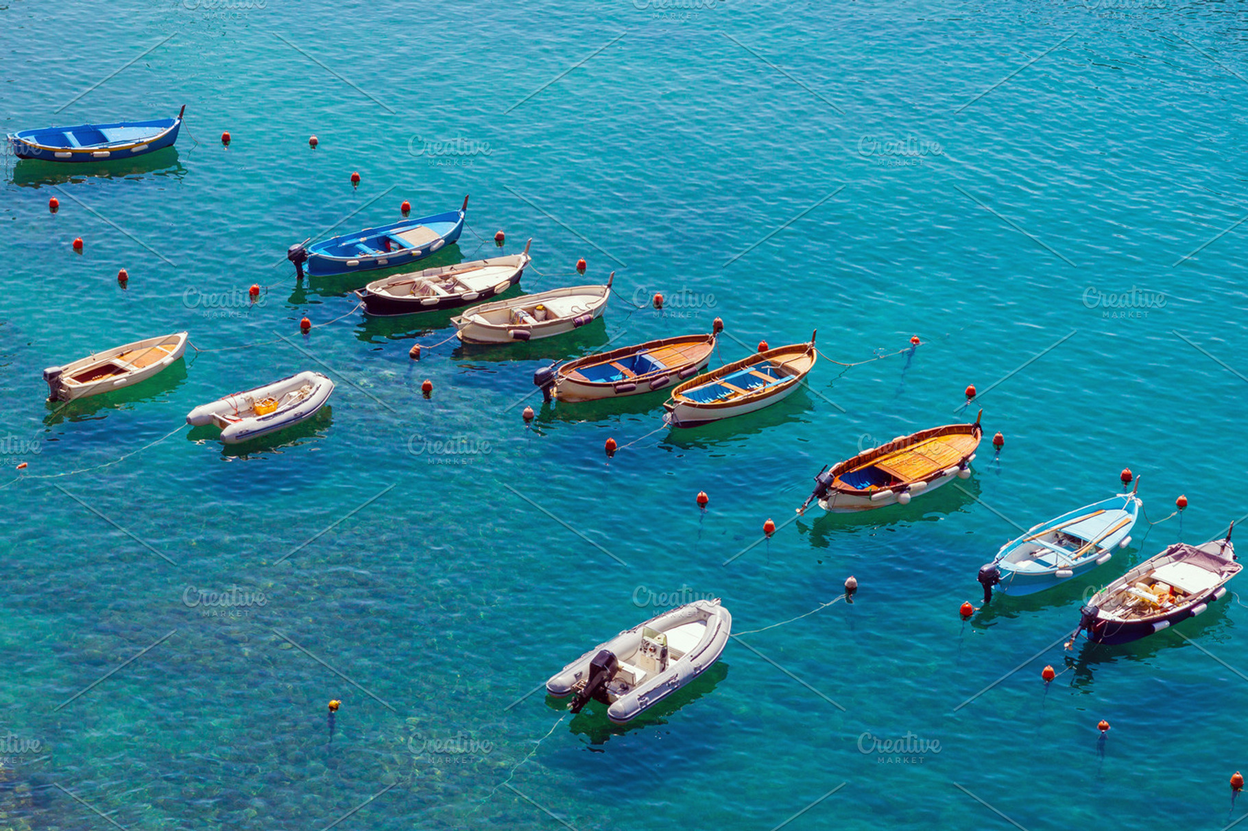 Small boats moored in calm lagoon, a Transportation Photo by BOOCYS