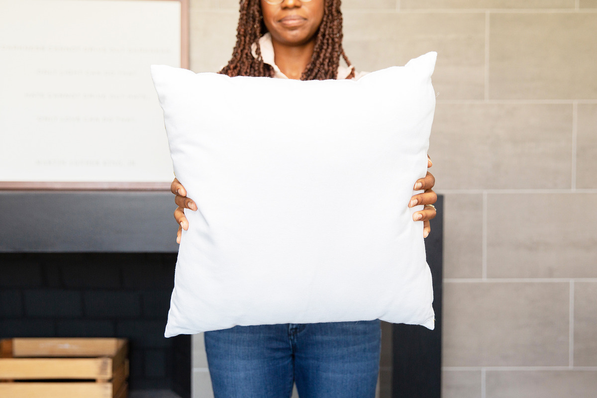 Black Model Holding Pillow Mockup, a Product Mockup by JENLYNN Stock Shop (Photo 3 of 4)
