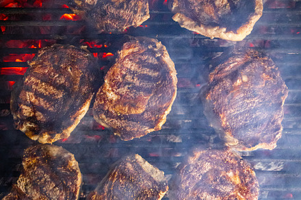 Steaks are generously covered in seasoning, a Photo by Grafvision photography