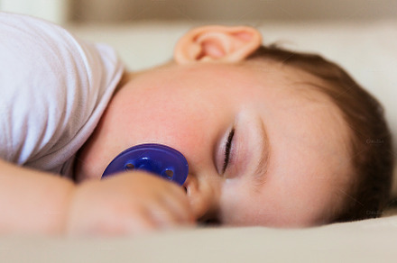 Toddler sleeping on the bed.