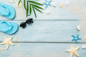 Summer beach essentials on wooden background, a Holiday Photo by Olena Rudo