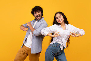Having fun. Joyful young indian couple dancing and fooling around, enjoying fav, a Person Photo by Prostock-Studio