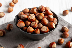 Organic Raw Hazelnuts in a Bowl, side view., a Food & Drink Photo by LiudmylaChuhunova