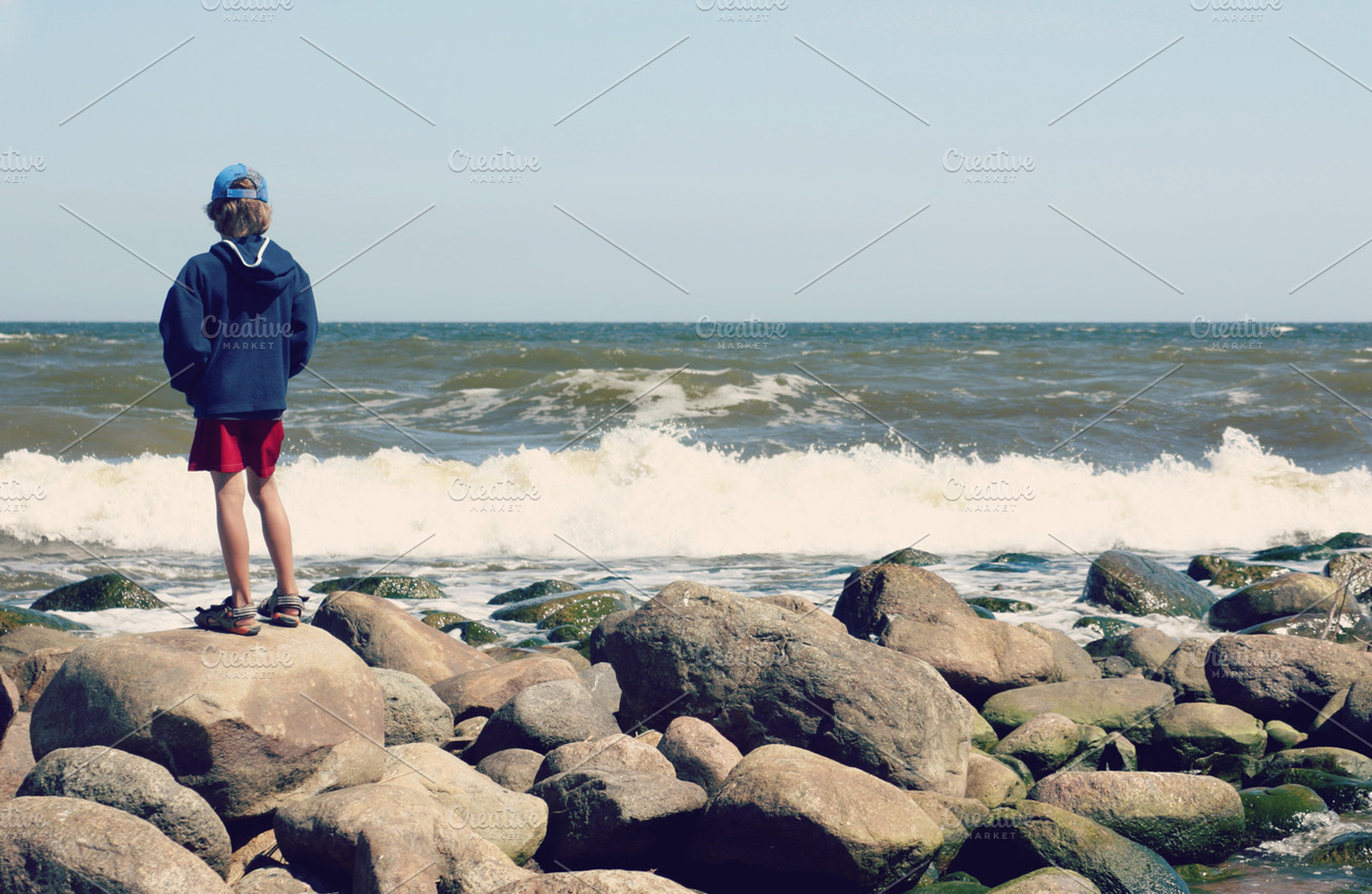 Boy looking at sea, a Person Photo by BOOCYS