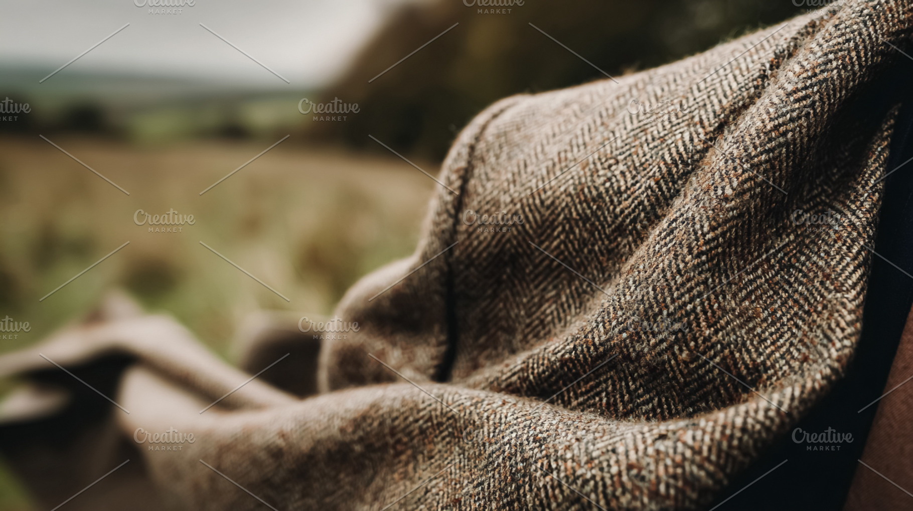 Tweed jacket with herringbone pattern, showing wool texture and, a Photo by Studio ANNA