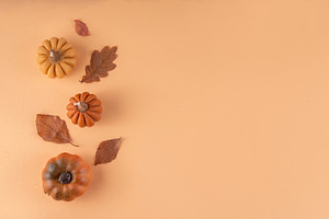 Autumn leaves and pumpkins flat lay on beige background, a Holiday Photo by Rimma