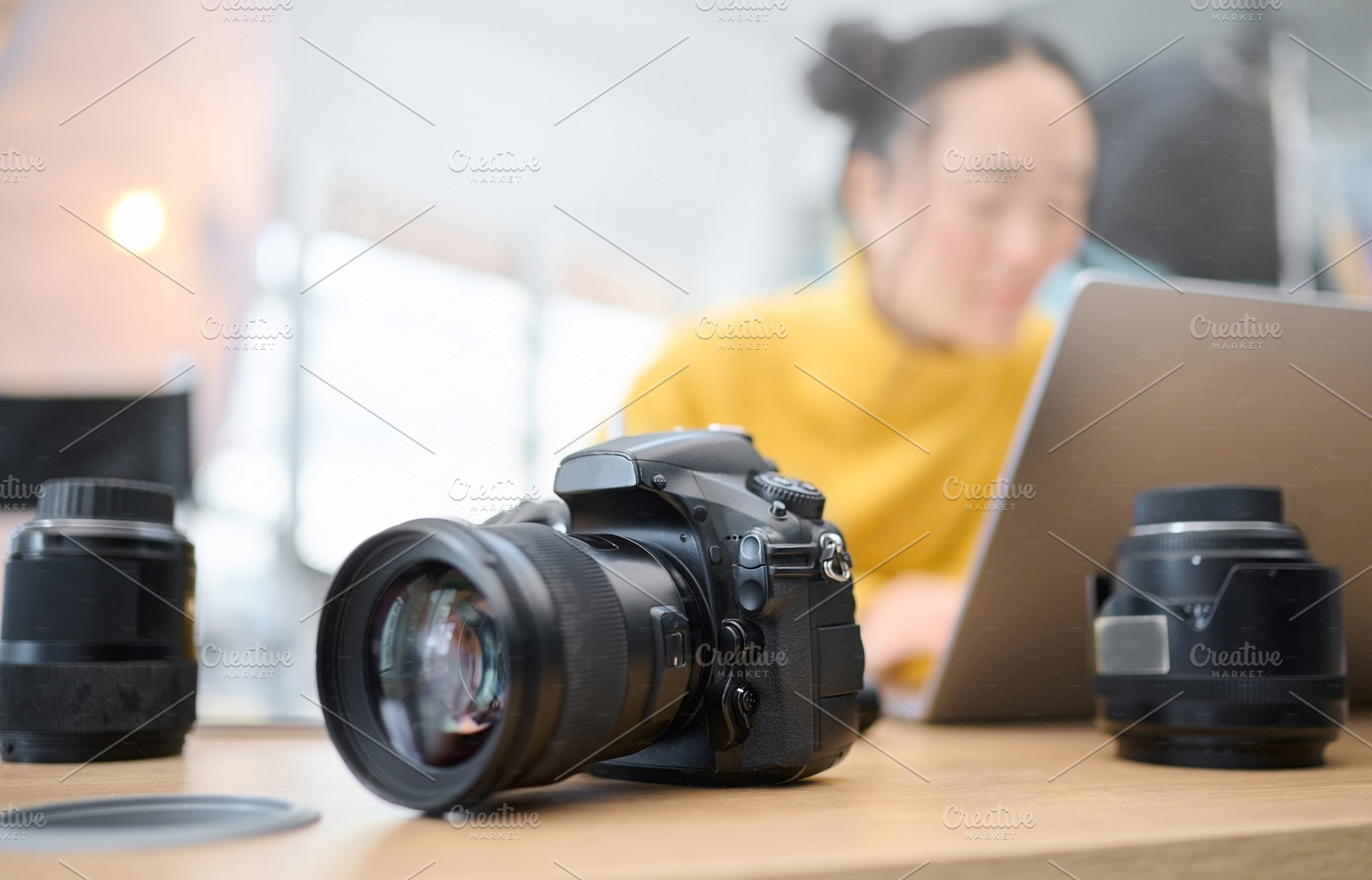 Photography camera, laptop and photographer editing photoshoot, focus on digital art or retouching artistic photo. Studio, creative vision and professional Asian woman working on creativity process, a Photo by Peopleimages.com