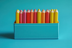 Colorful pencils in teal box vibrant, a Background Photo by Pixeness Studio