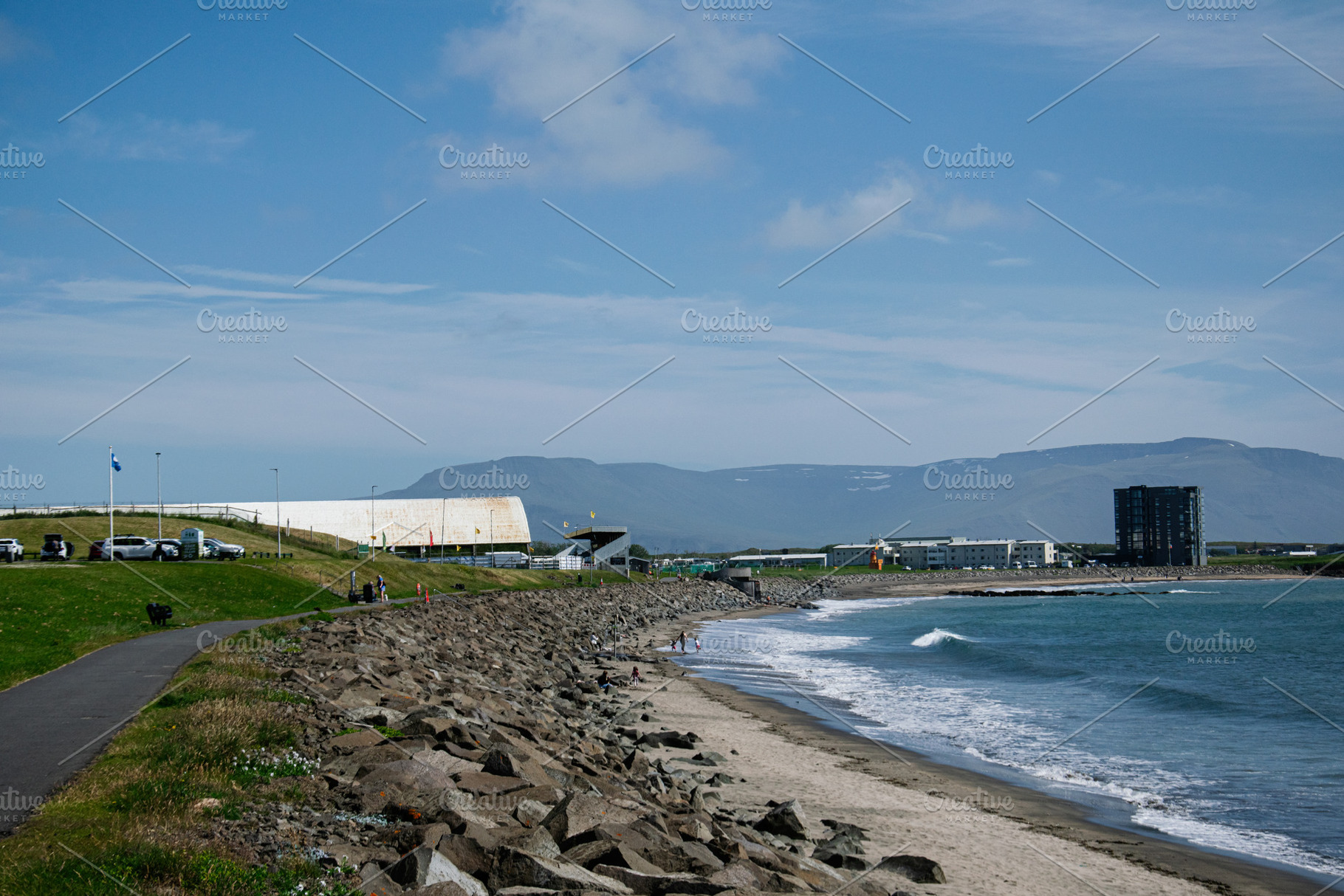 Seaside view in Akranes, Iceland with mountains and blue sky, a Photo by AS photostudio