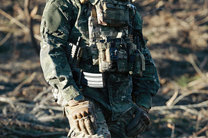Soldier wearing camouflage uniform and tactical vest patrolling in forest, a Sports & Recreation Photo by Antonio Gravante Market