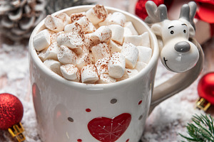 Reindeer mug holding hot chocolate with marshmallows in snow, a Holiday Photo by Olena Rudo