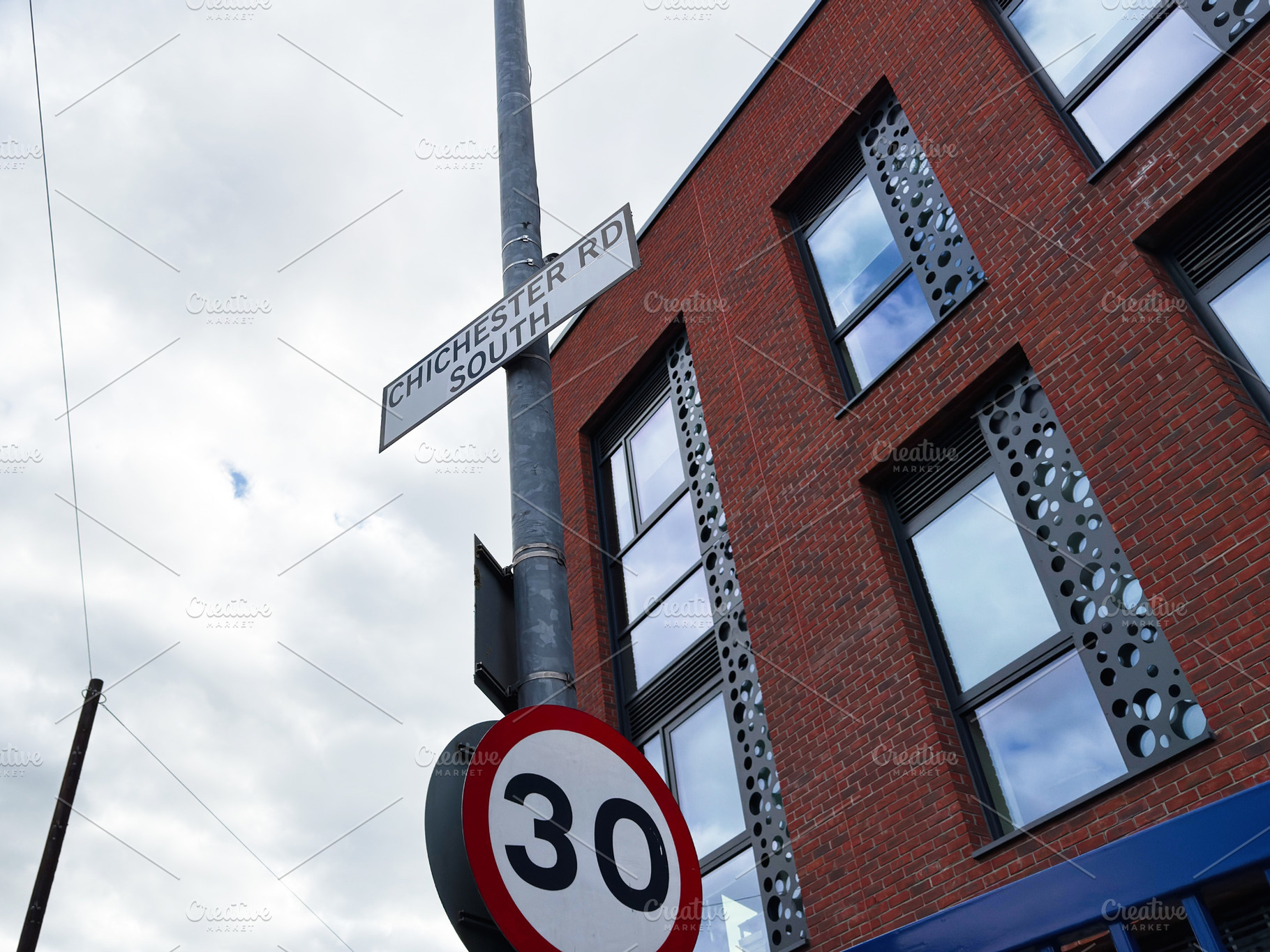 Street pole with 30 speed limit sign and Chichester Rd South nex, a Photo by AS photostudio