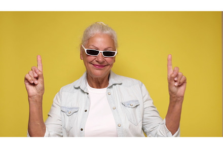 An elderly woman points her finger