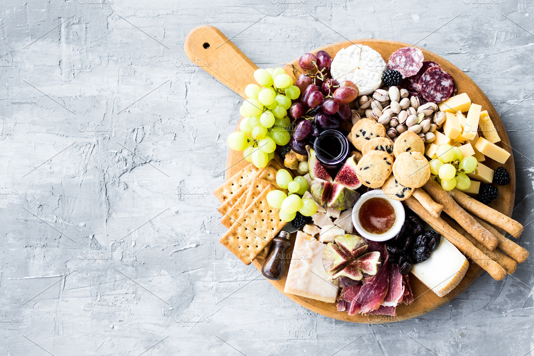 Assortment of tasty appetizers or containing charcuterie, cheese, and platter, a Food & Drink Photo by NelliKovalchuk