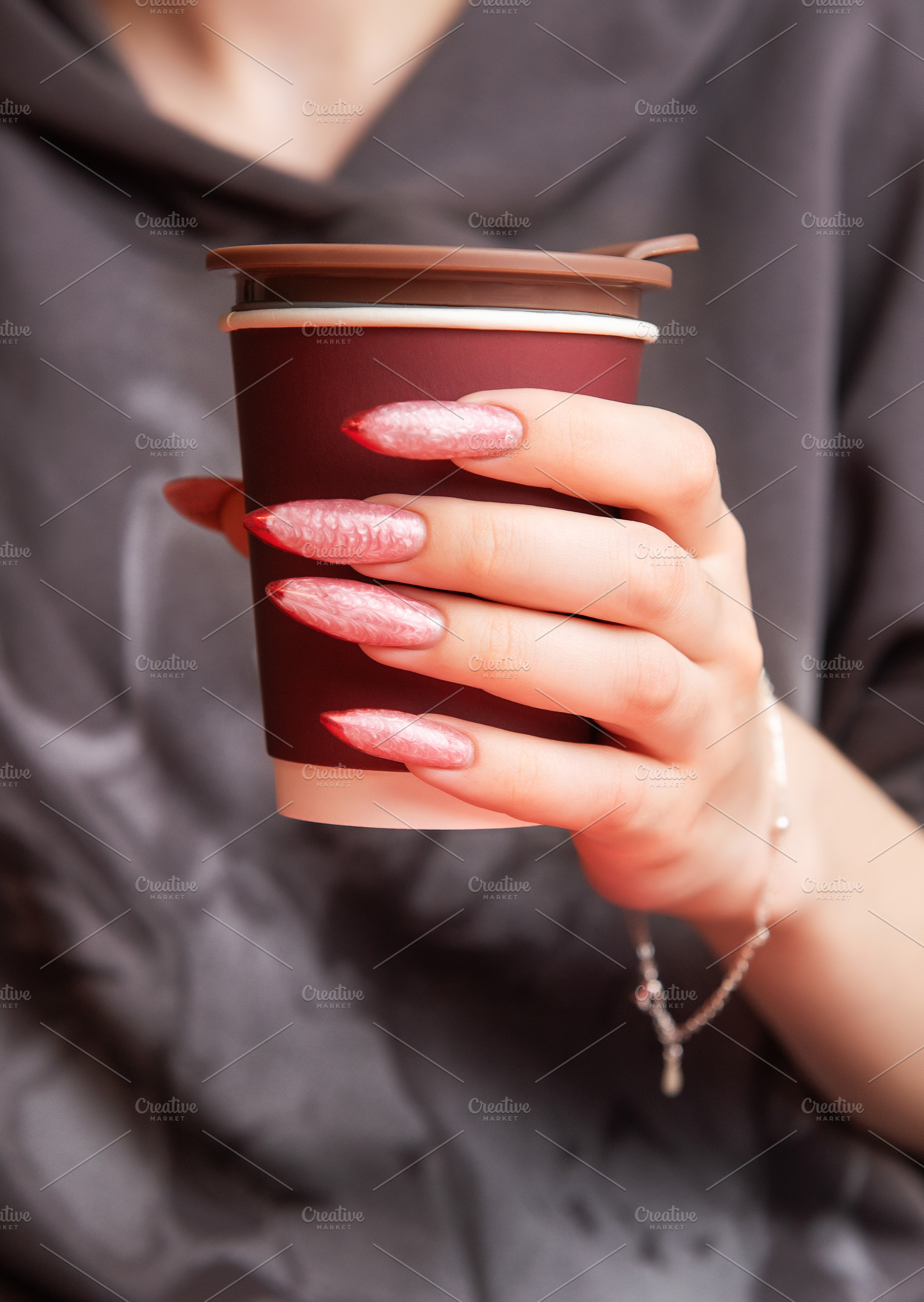 Woman holding paper cup with stylish long nails, a Beauty & Fashion Photo by Olena Rudo
