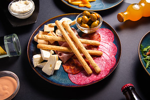 Beer snack plate with cheese, salami, ham, bacon, jamon, breadst, a Food & Drink Photo by MDBildes