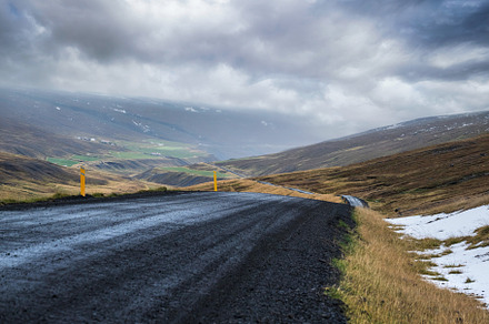 Gravel road and mountain view during auto trip in Iceland.  Spec, a Nature Photo by YuriyB