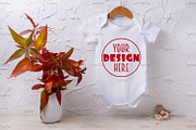 Baby bodysuit mockup with red grass, a Shirt Mockup by TasiPas (Thumbnail 1 of 4)