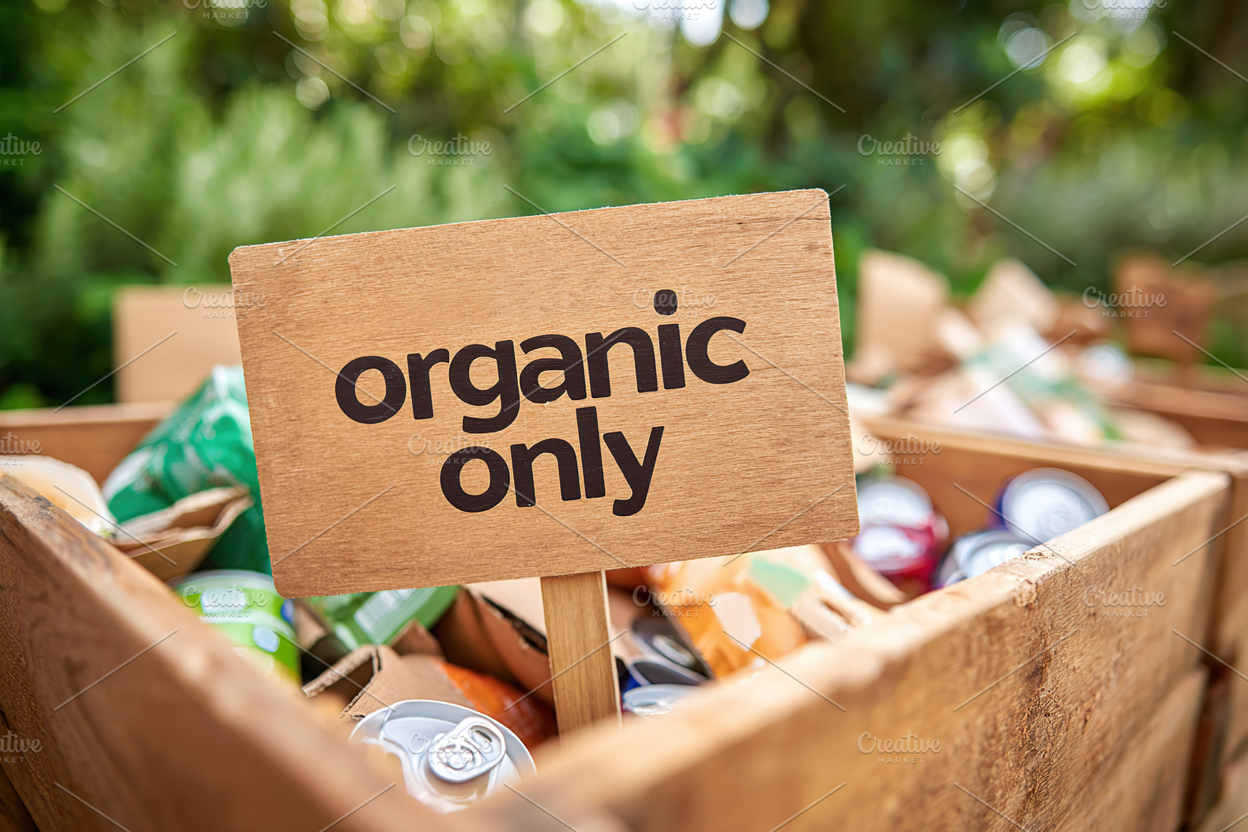 Organic only sign in a wooden box filled with assorted organic cans in a lush g, a Background Photo by AlyaAnd