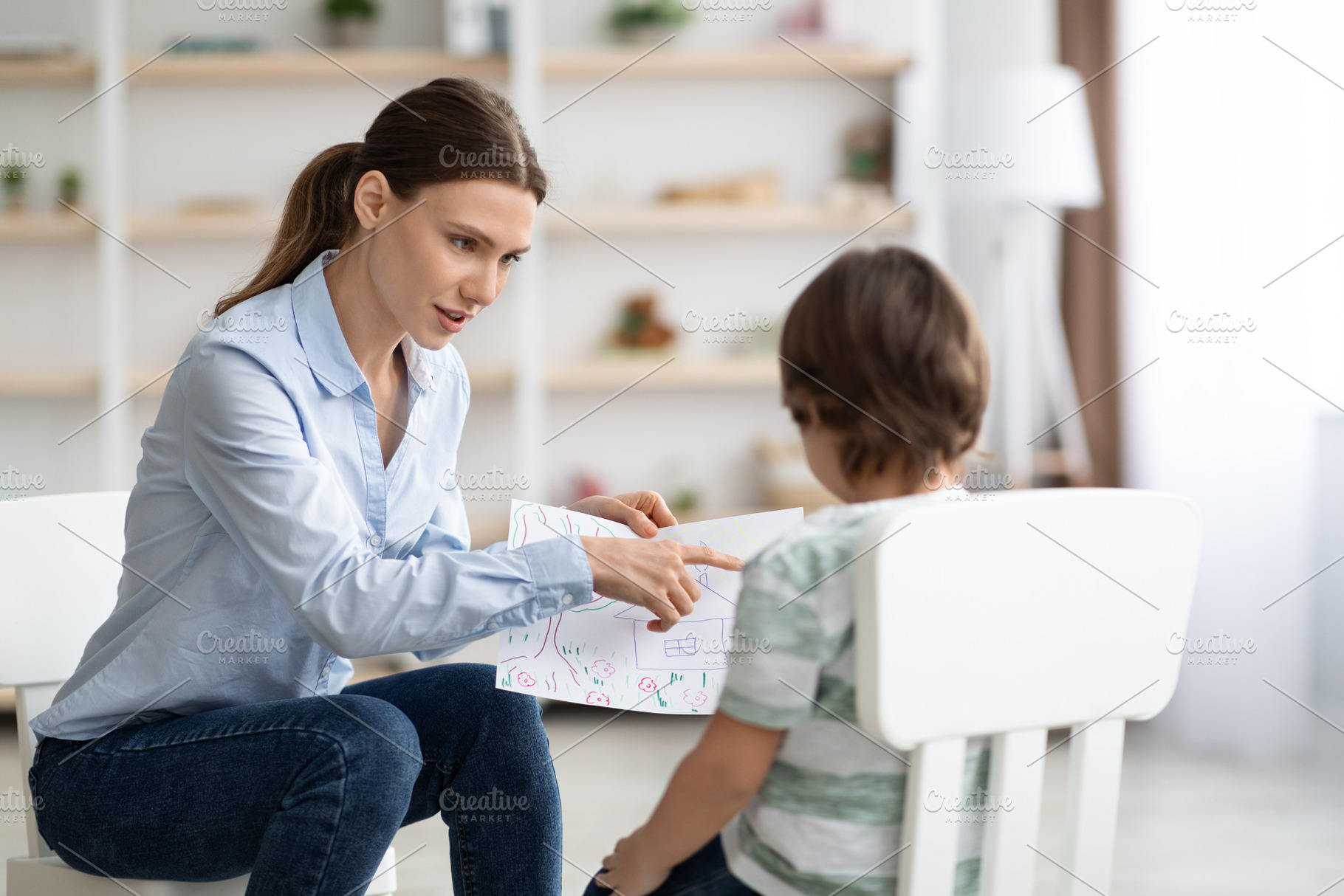 Modern methods of kids psychological diagnostics. Professional woman psychologi, a Photo by Prostock-Studio