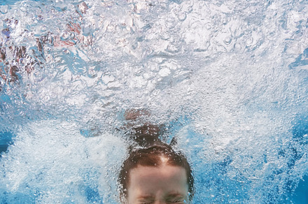 Child jump underwater in pool, a Sports & Recreation Photo by Tropical Studio