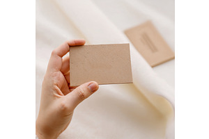 Hand holds a business card. A close, a Mockup by Canatic