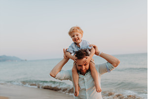 Father carrying toddler on the, a Person Photo by HalfPoint