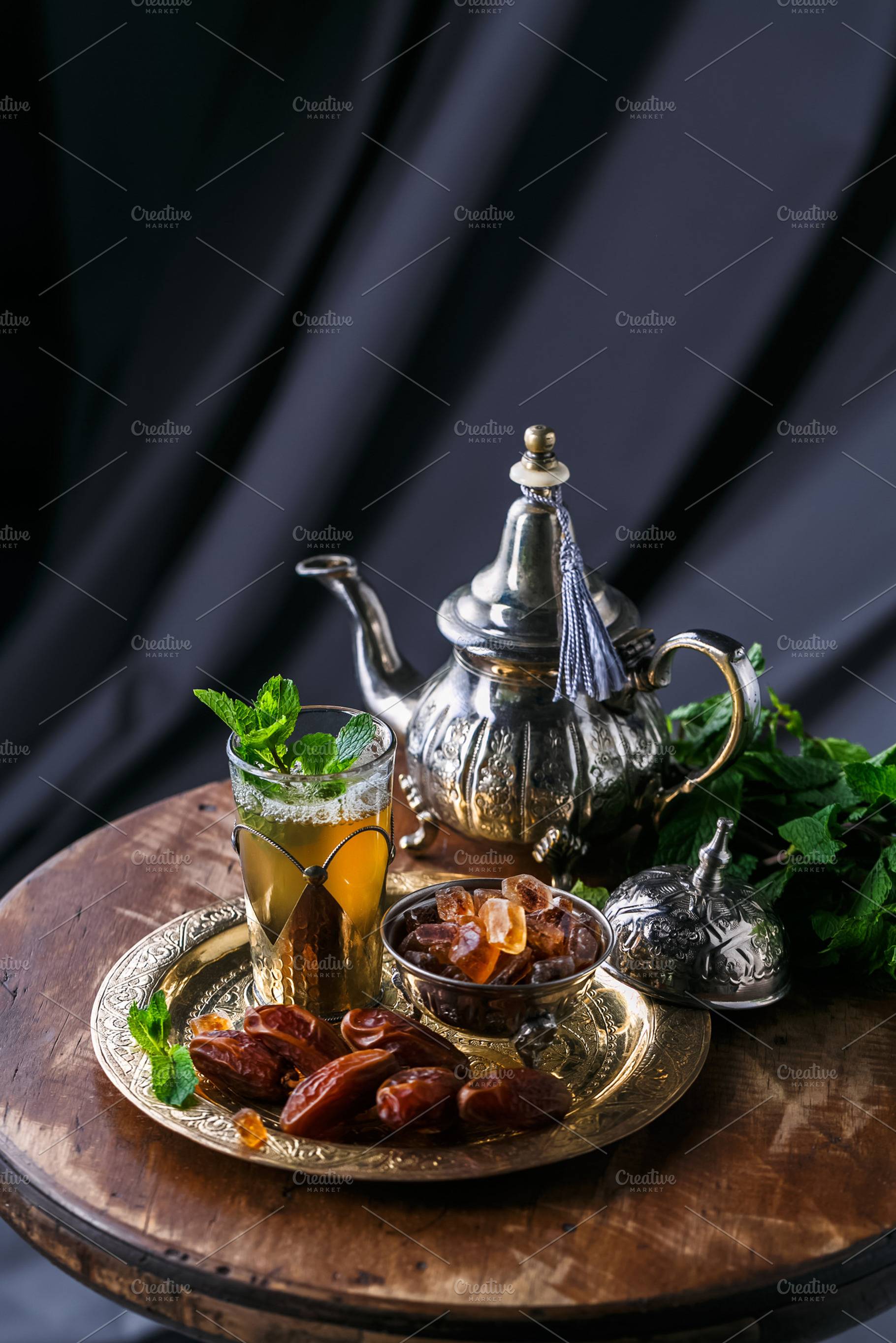 Glass of mint tea with dates and sugar on copper plate featuring moroccan, a Food & Drink Photo by Konstantin K.