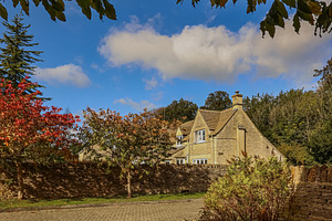 Traditional English stone cottage surrounded by autumn foliage and dry stone wa, a Photo by Studio ANNA
