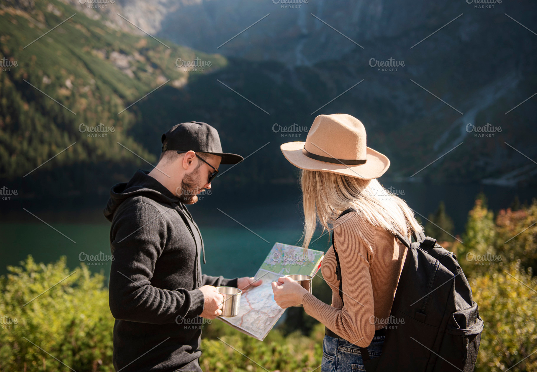 Young tourist couple, man and woman, on hiking path in mountains, a Person Photo by Olena Rudo