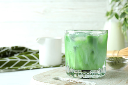 Matcha latte and accessories for making on white wooden table, a Food & Drink Photo by AtlasStudio PRO